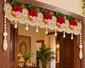 May include: A decorative door hanging featuring a scalloped gold mesh base adorned with artificial red, pink, and yellow roses, green leaves, and white crystal-like accents. The piece includes hanging white pearl tassels and side strands.