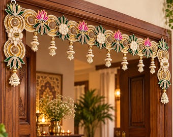 May include: A decorative door hanging featuring a horizontal arrangement of circular gold discs, white floral motifs, and pink and green lotus-shaped accents. The piece includes dangling beaded tassels and is designed to frame a doorway.