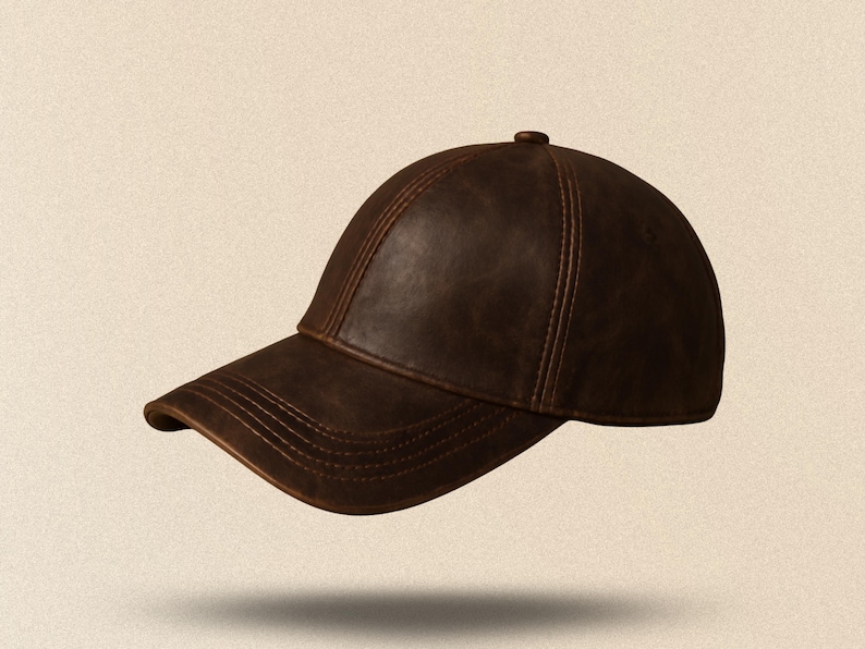 May include: A brown leather baseball cap with a curved brim. The cap has a classic six-panel design with visible stitching and a small button on top. The hat appears to be made of a distressed leather material.