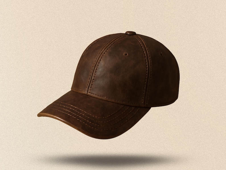 May include: A brown leather baseball cap with a curved brim. The cap has a classic six-panel design with stitching details and a button on top. The hat appears to be made of a distressed leather material.