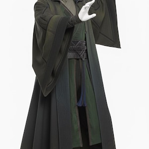 May include: A dark green hooded robe with long, flowing sleeves. The costume features a layered design with varying shades of green and black, a detailed belt, and a long, dark tassel. The outfit is completed with dark boots.