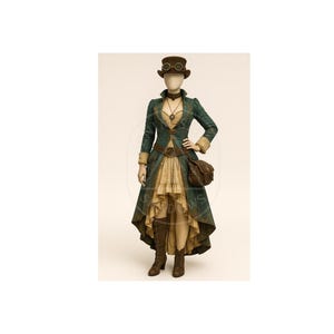 May include: A steampunk-inspired outfit on a mannequin. The ensemble includes a teal coat with gold accents, a tan skirt, brown boots, a matching hat with goggles, and a satchel. The outfit is designed with a Victorian aesthetic.