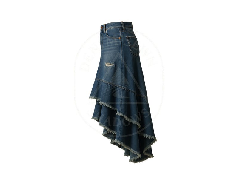 May include: A denim skirt with a unique asymmetrical design. The skirt features a distressed look with a ripped detail and frayed edges. The skirt has a classic five-pocket design and a button and zipper closure.