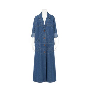 May include: A long, denim duster coat with a classic collar and button-down front. The coat features large patch pockets and rolled-up sleeves. The garment is displayed on a mannequin against a white background.