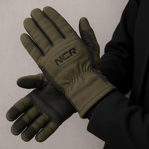 May include: Olive green gloves with black accents. The gloves feature the letters "NCR" embossed on the back of the hand. The gloves appear to be made of a durable, weather-resistant material, suitable for outdoor activities.