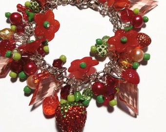 Strawberry charm bracelet with red rhinestone strawberry charm in red, pink and green bead clusters, cha cha bracelet with red flowers