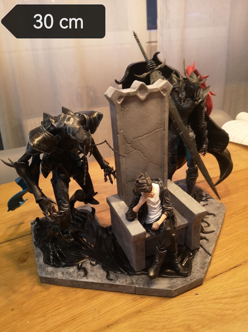 May include: A detailed figurine depicting a fantasy scene with three figures. The central figure sits on a stone throne, flanked by two armored characters. The base measures approximately 11.8 inches in length.