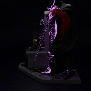 May include: A detailed statue of a warrior in black armor, cape, and a large sword, illuminated with purple light. A red accent is visible on the cape. A person is seated on a stone structure in the background. The overall theme is fantasy.