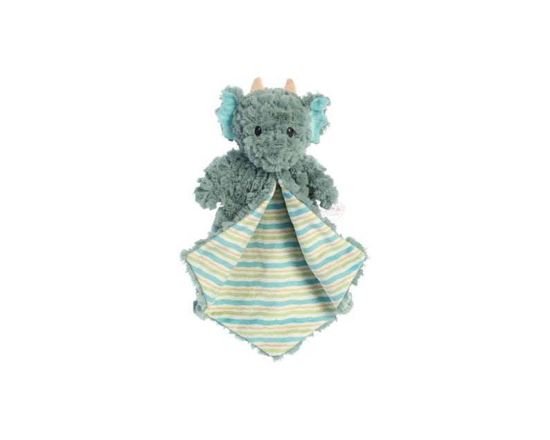 a stuffed elephant is wrapped in a blanket