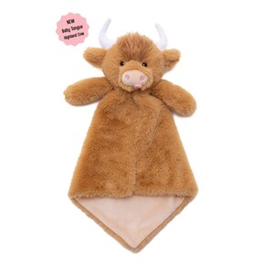 A brown stuffed toy cow with horns, resembling a Highland cow, is displayed against a white background.