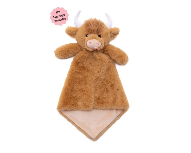 A brown stuffed toy cow with horns, resembling a Highland cow, is displayed against a white background.