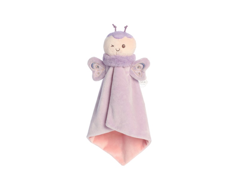 a stuffed toy angel hanging on a wall