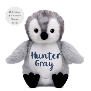 May include: A plush penguin toy with gray and white fur, black feet, and a black beak. The white belly features the embroidered text Hunter Gray in dark blue. A circular badge in the top left corner displays the text 45 Animals & Colors to Choose From.