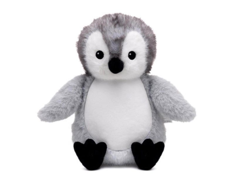 A plush toy penguin with a gray and white body and black feet is sitting on a white background.