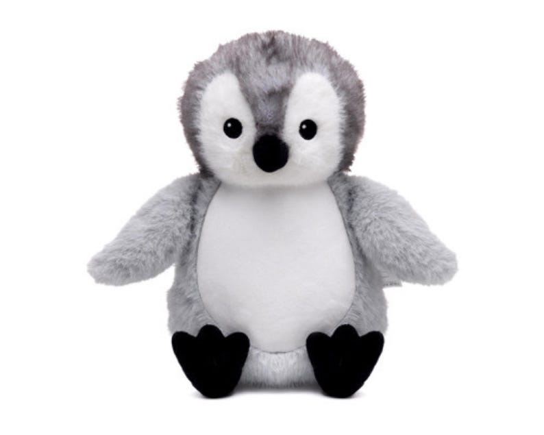 A plush toy penguin with a gray and white body and black feet is sitting on a white background.