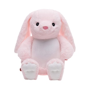 A pink stuffed bunny toy is sitting on a white background.
