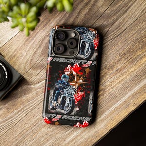 May include: Black phone case with a motorcycle design. The case features a graphic of a motorcycle and the text "ROCKET 3 GT" in white and red. The case is on a wooden surface.