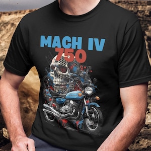 May include: Black t-shirt with a graphic of a skull and a blue motorcycle. The text "MACH IV 750" is in blue and red. The motorcycle has blue and red paint splatter details.