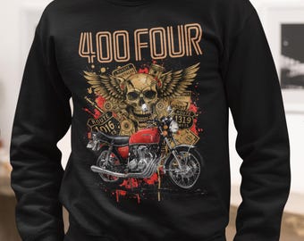 May include: Black sweatshirt with a motorcycle graphic. The design features a red motorcycle, a skull with wings, and the text "400 FOUR" in gold. Route signs and engine parts complete the design.