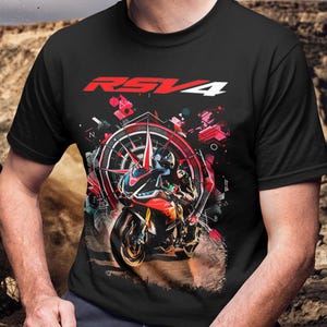 May include: Black t-shirt featuring a graphic of a red and black motorcycle with the text "RSV4" in red and white. The design includes a compass-like element and abstract red and pink shapes.
