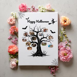 May include: A white canvas print featuring a black tree with pumpkin-shaped frames holding photos. The words "Happy Halloween" are above the tree, with bats and a witch silhouette. Pink and orange flowers surround the canvas.