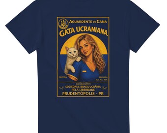 May include: Navy blue t-shirt featuring a vintage-style graphic. The graphic depicts a woman with a cat, and text that reads "AGUARDENTE DE CANA GATA UCRANIANA". The shirt is made of a soft material.