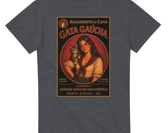 May include: Dark gray t-shirt featuring a vintage-style illustration. The design includes a woman holding a cat, with text that reads "Gata Gaúcha" and "Aguardente de Cana". The shirt has a classic crew neck.