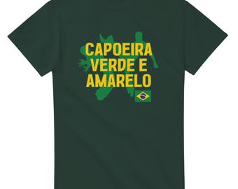 May include: Dark green t-shirt with the words "CAPOEIRA VERDE E AMARELO" in yellow and green. The design includes a silhouette of a capoeira figure and the Brazilian flag. A casual tee for fans of Brazilian culture.