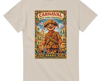 May include: Beige t-shirt featuring a colorful graphic of a smiling carnival figure with the text "CARNAVAL RECIFE-OLINDA-PERNAMBUCO BRASIL". The design includes a detailed illustration of a festive scene with buildings and people.