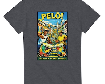 May include: Dark gray t-shirt featuring a colorful graphic of two musicians playing drums in a street scene. The graphic includes the word "PELO!" and the text "SALVADOR - BAHIA - BRASIL". The drums are decorated with vibrant colors.