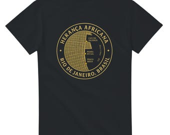 May include: Black t-shirt featuring a gold circular graphic with the text "HERANÇA AFRICANA" and "RIO DE JANEIRO, BRASIL". The graphic includes a map-like design with place names. A stylish and comfortable tee.