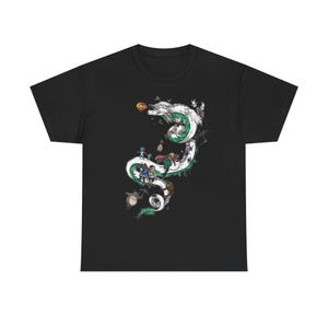 May include: Black t-shirt featuring a white and green dragon design with various animated characters. The dragon winds across the shirt, with detailed illustrations of characters and objects. The design is a vibrant and detailed graphic.