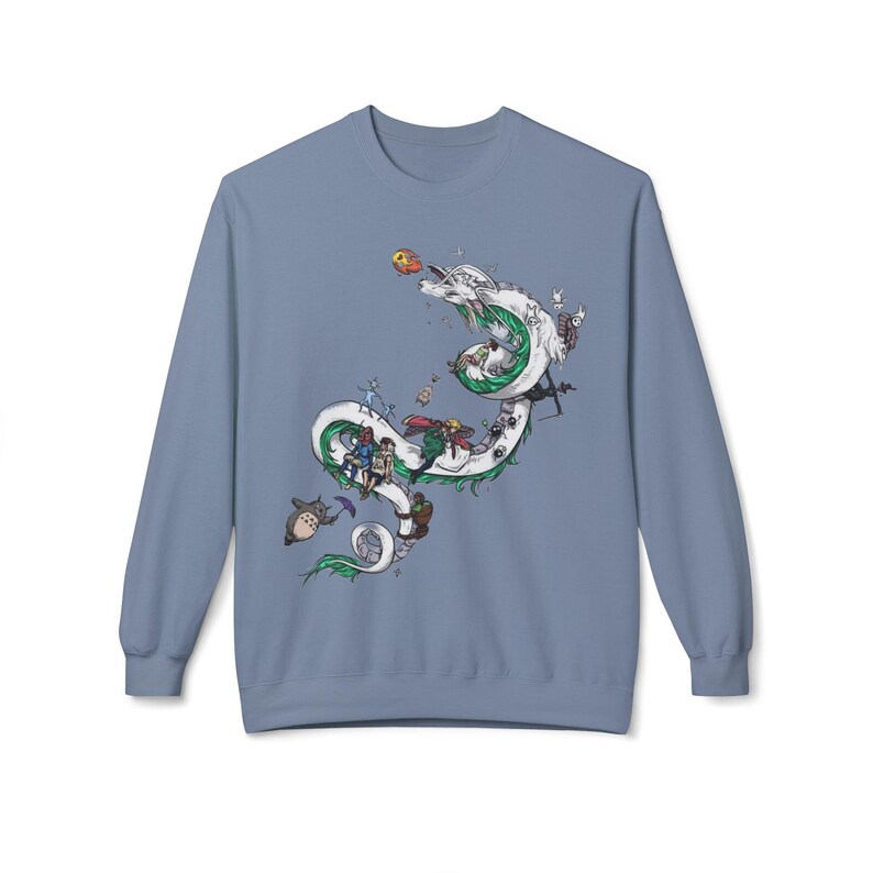 May include: A light blue sweatshirt featuring a whimsical illustration of a white dragon with green accents, adorned with various animated characters. The design includes a variety of colorful figures and objects, creating a playful and imaginative scene.