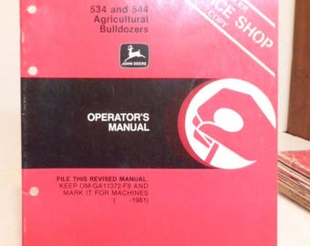 May include: A red and black manual for 534 and 544 Agricultural Bulldozers. The cover features the John Deere logo, the words "OPERATOR'S MANUAL", and "SERVICE SHOP COPY". The manual includes the text "FILE THIS REVISED MANUAL" and "Plow & Planter Works".