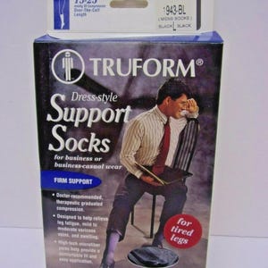May include: A box of Truform dress-style support socks featuring 15-25 mmHg of compression. The packaging displays a person sitting on a chair, the text 'Support Socks', 'Firm Support', and 'for tired legs', along with product details.