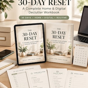 May include: A digital tablet and a physical book titled The 30-Day Reset: A Complete Home & Digital Declutter Workbook, accompanied by a 30-day calendar and printed checklists for home, digital, and weekly decluttering tasks on a desk.