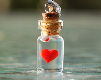 Heart in tiny bottle charm.