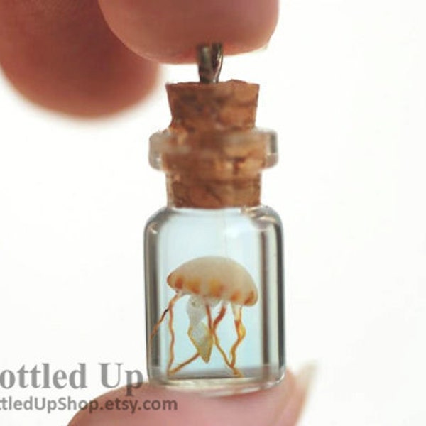Tiny Glow-in-the-Dark Jellyfish in a Bottle pendant on necklace.