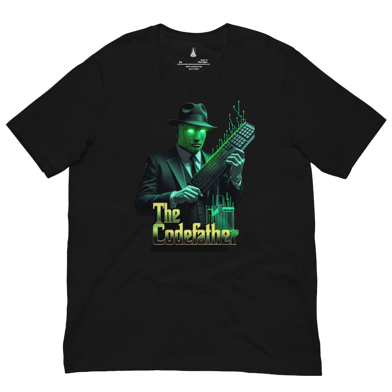 May include: A black short-sleeve t-shirt featuring a graphic of a figure in a suit and fedora with a glowing green digital face, holding a computer keyboard. The text "The Codefather" appears below in green and yellow lettering with circuit patterns.