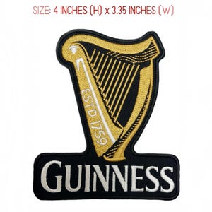 May include: An embroidered patch featuring a gold harp on a black background with the text ESTD 1759 and the word GUINNESS in white lettering. The patch measures 4 inches in height by 3.35 inches in width, with a black border outline.