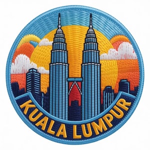 May include: A circular embroidered patch featuring the Petronas Twin Towers in Kuala Lumpur against a yellow sun and orange sky. The design includes white clouds, a dark blue cityscape, and the text KUALA LUMPUR in yellow on a dark blue banner.