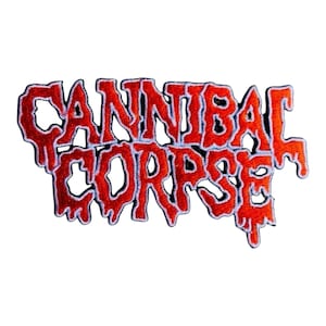 May include: An embroidered patch featuring the text CANNIBAL CORPSE in a stylized, dripping font. The lettering is bright red with a thin white border, creating a high-contrast design. The edges of the letters appear to melt downward.