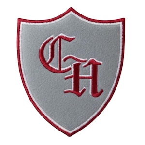 May include: A gray shield-shaped patch with a red and white border. The patch features the embroidered letters "CH" in a decorative red font. The patch is likely for a school, club, or organization.