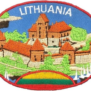 May include: An oval embroidered patch featuring a castle with orange-brown roofs and stone walls, surrounded by green trees and a blue sky. The word LITHUANIA is stitched in white at the top, and a yellow, green, and red flag design is at the bottom.