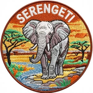 May include: Embroidered patch featuring an elephant in a savanna landscape. The patch is circular, with the word "SERENGETI" arched across the top in white. The elephant is gray and white, with a detailed depiction of the African savanna.