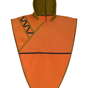 May include: An orange poncho with a hood, featuring olive green trim and accents. The poncho has a quilted diamond pattern on the front and a zigzag design. A navy blue stripe runs across the front.