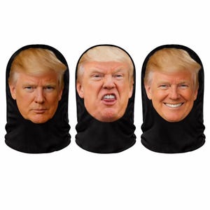 May include: Three black face coverings each featuring a different facial expression of a man with blonde hair. The expressions include a neutral face, an angry face, and a smiling face.