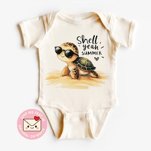 May include: Cream-coloured baby onesie with a cartoon turtle wearing sunglasses. The turtle is on a sandy beach with the words "Shell yeah, SUMMER" and a heart symbol. The onesie has short sleeves and a snap closure.