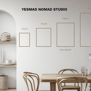 May include: A wall with framed art prints in various sizes, including 12x16, 16x20, 18x24, and 24x36 inches. The text "YESMAD NOMAD STUDIO" is at the top. The scene includes a dining table, chairs, and decorative elements.
