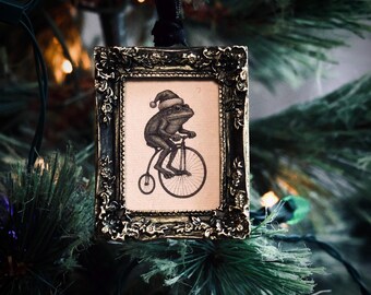 Vintage Style Santa Hat Frog on Bike Ornament in Baroque Frame | Unique Christmas Decoration | Whimsical Gothic Gift | Creepmas & Gothmas